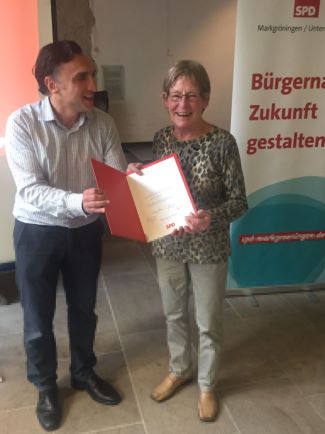 Ortsvereinsvorsitzender Tayyar Sengül (links im Bild) übergibt Ursula Kienzler die Ehrungsurkunde